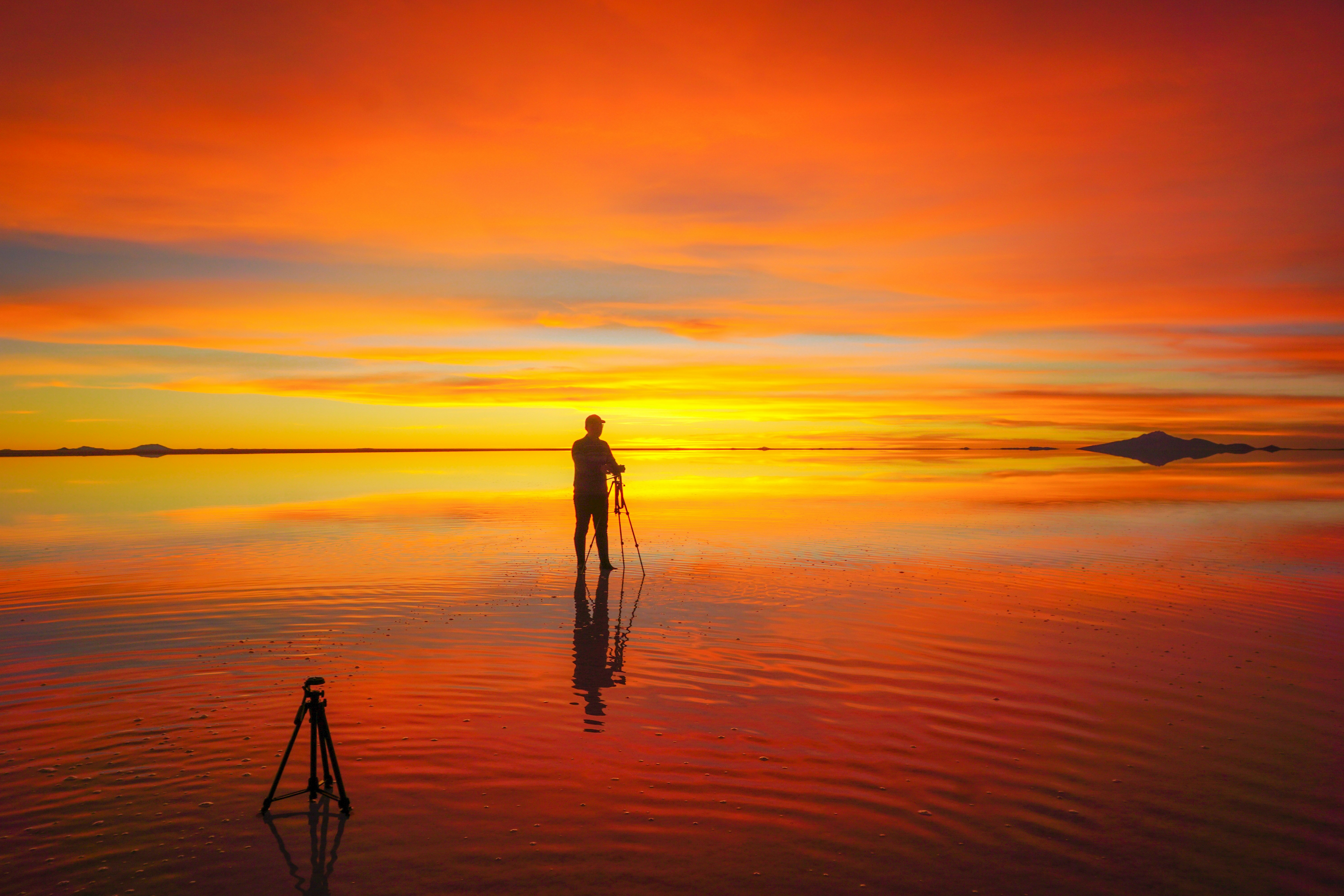 a person standing in the water with a surfboard