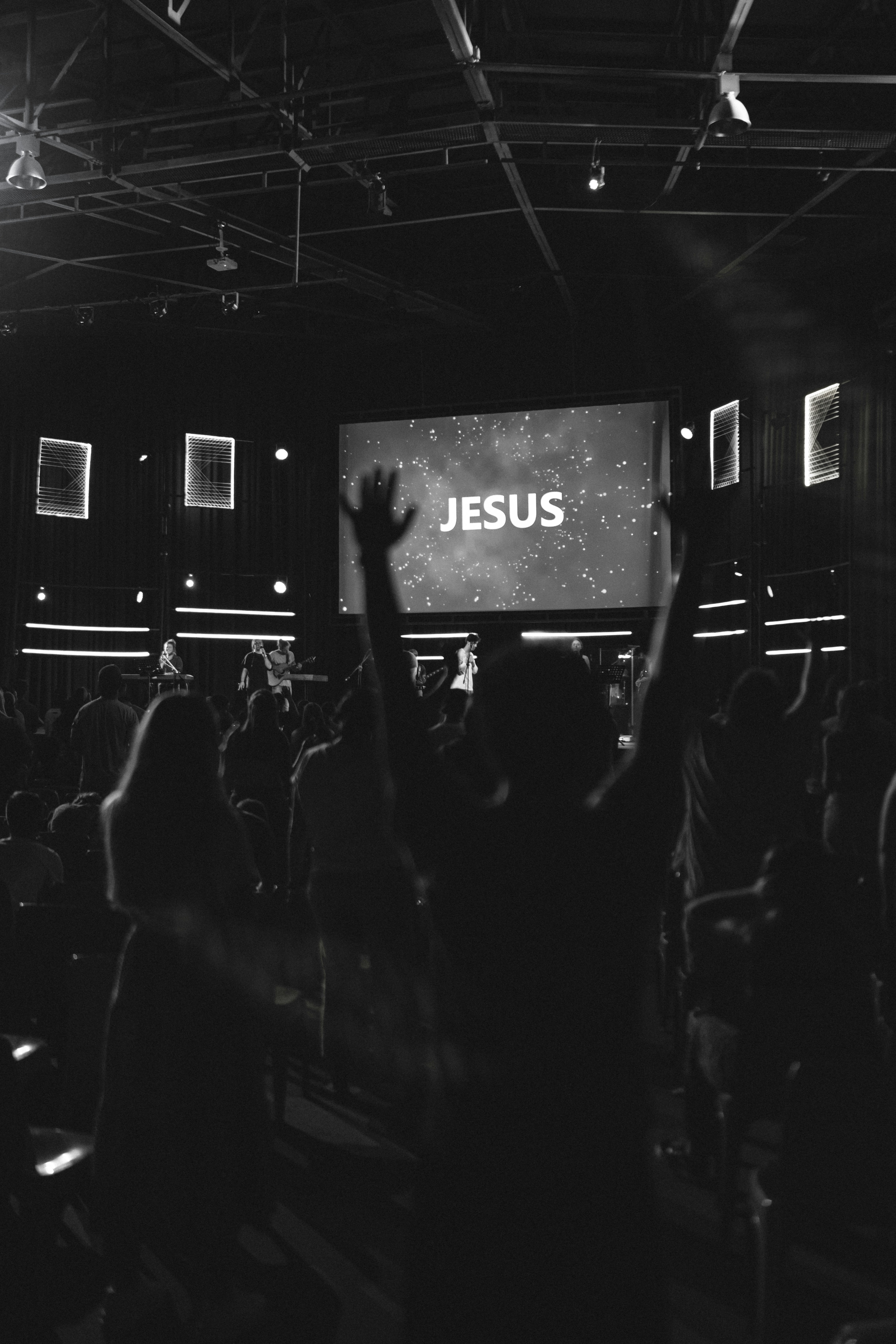 Congregation in worship with hands raised