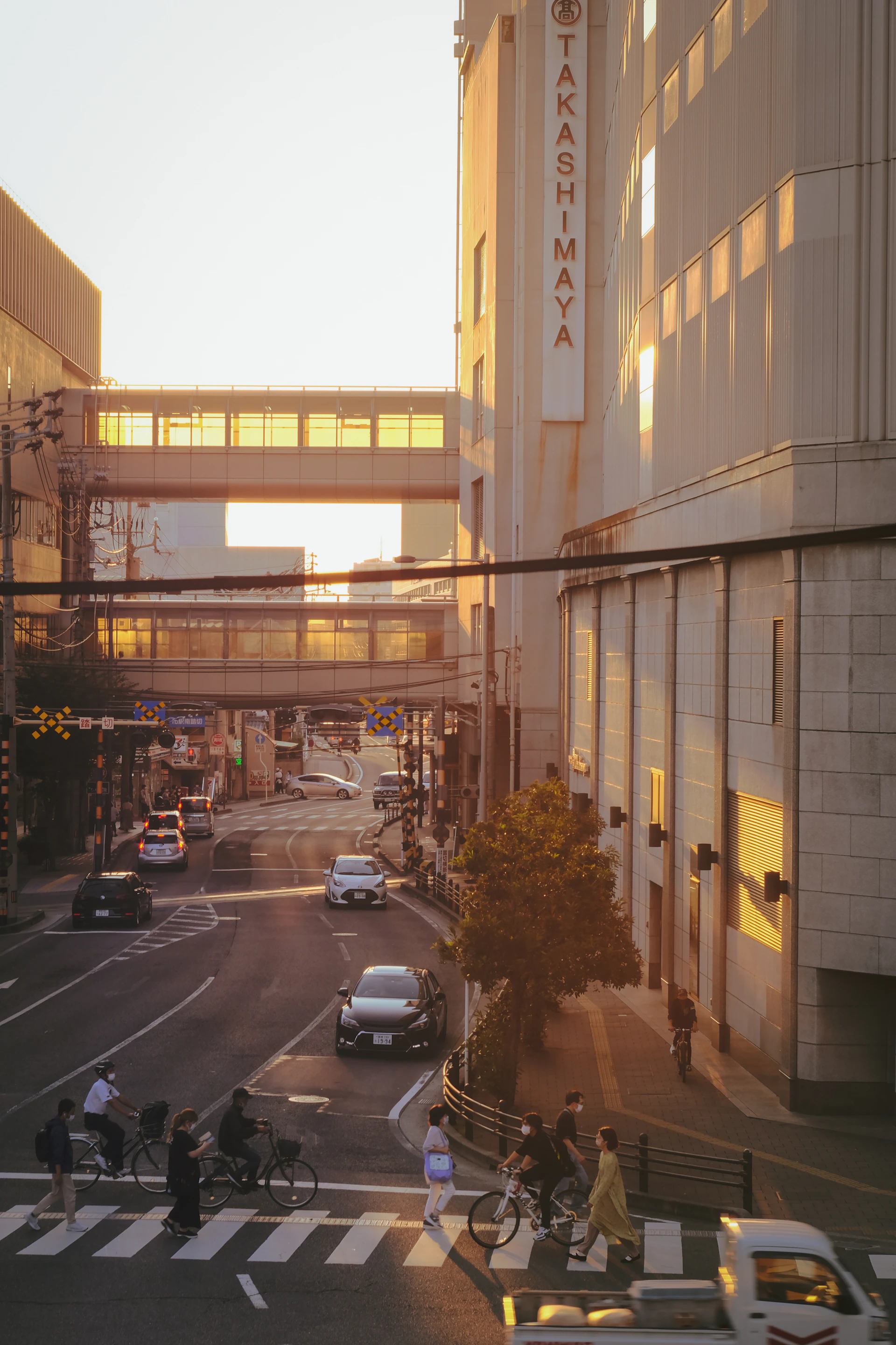 A vibrant photo of a bustling city street at sunset, capturing warm golden light and lively crowds.