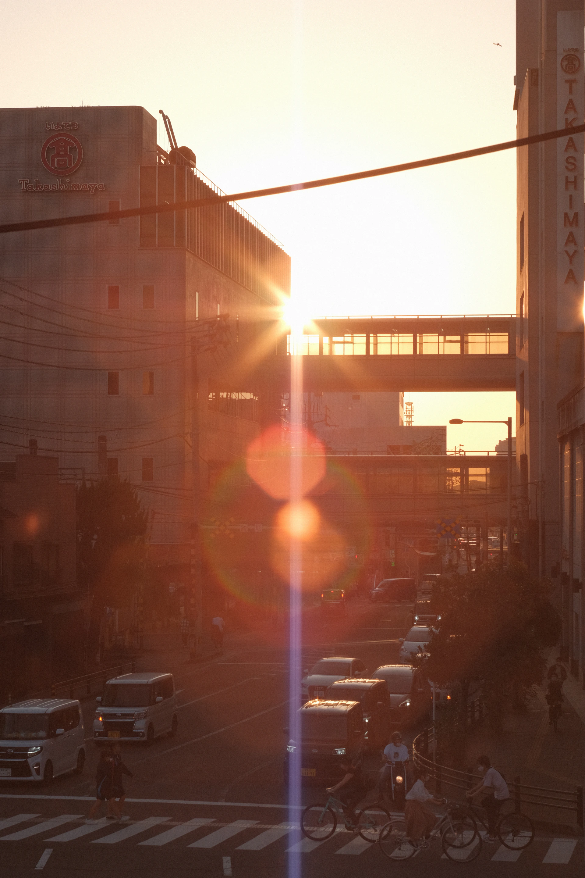 the sun is setting over a busy city street