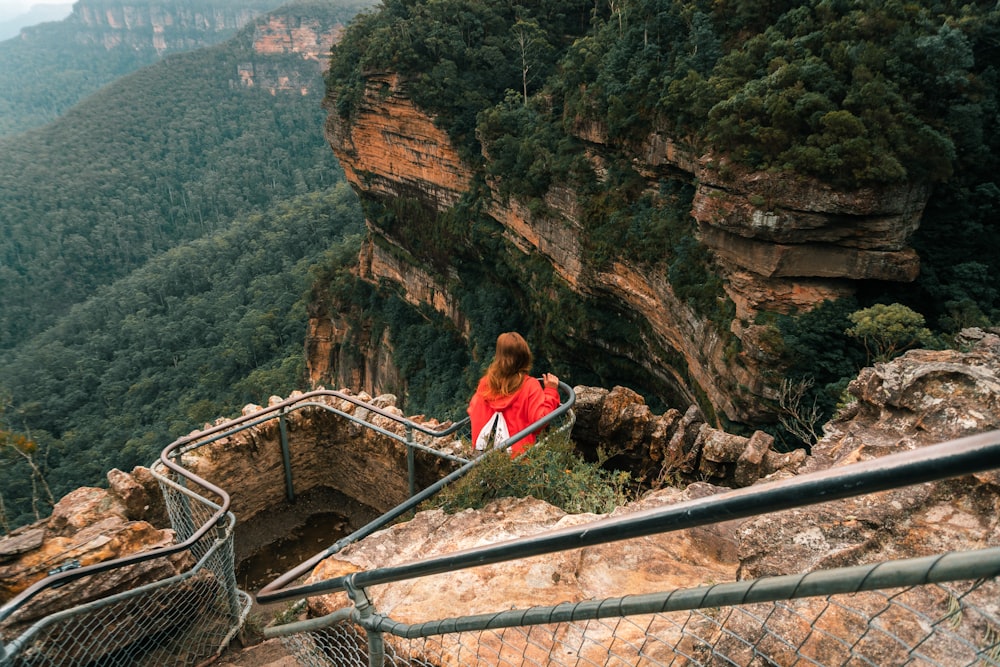 a woman is walking up a set of stairs