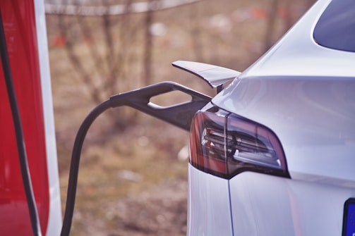 a white car is at a gas pump