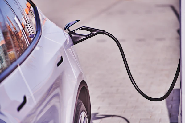 White electric car plugged into a charger