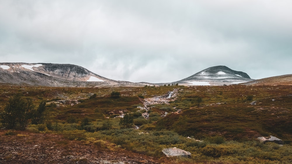 a mountain range with a trail leading to it