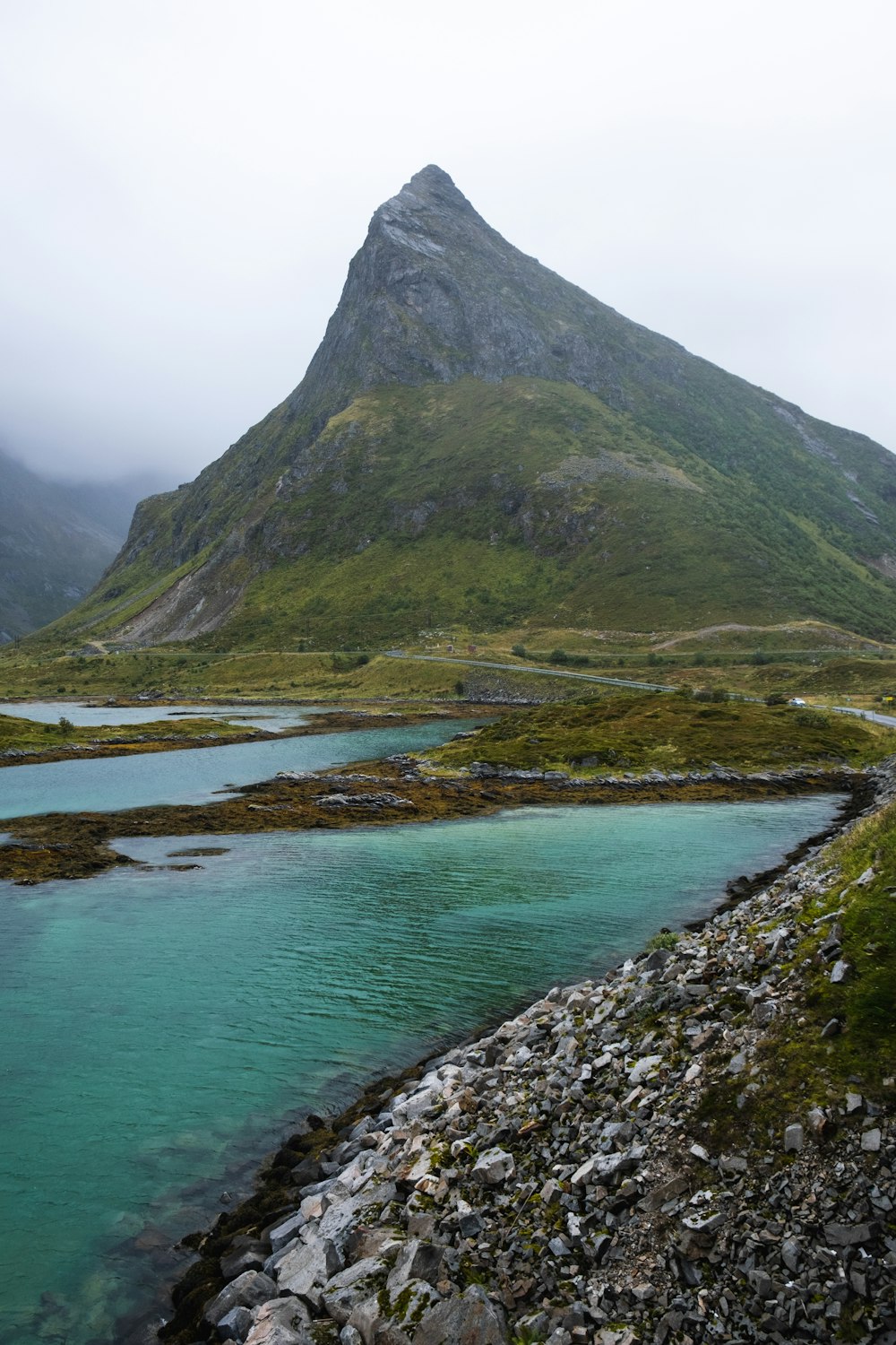 a mountain with a body of water in front of it