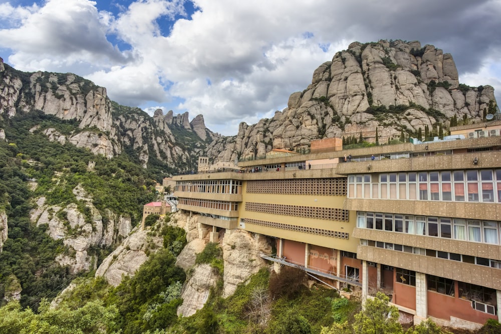 a very tall building sitting on the side of a mountain