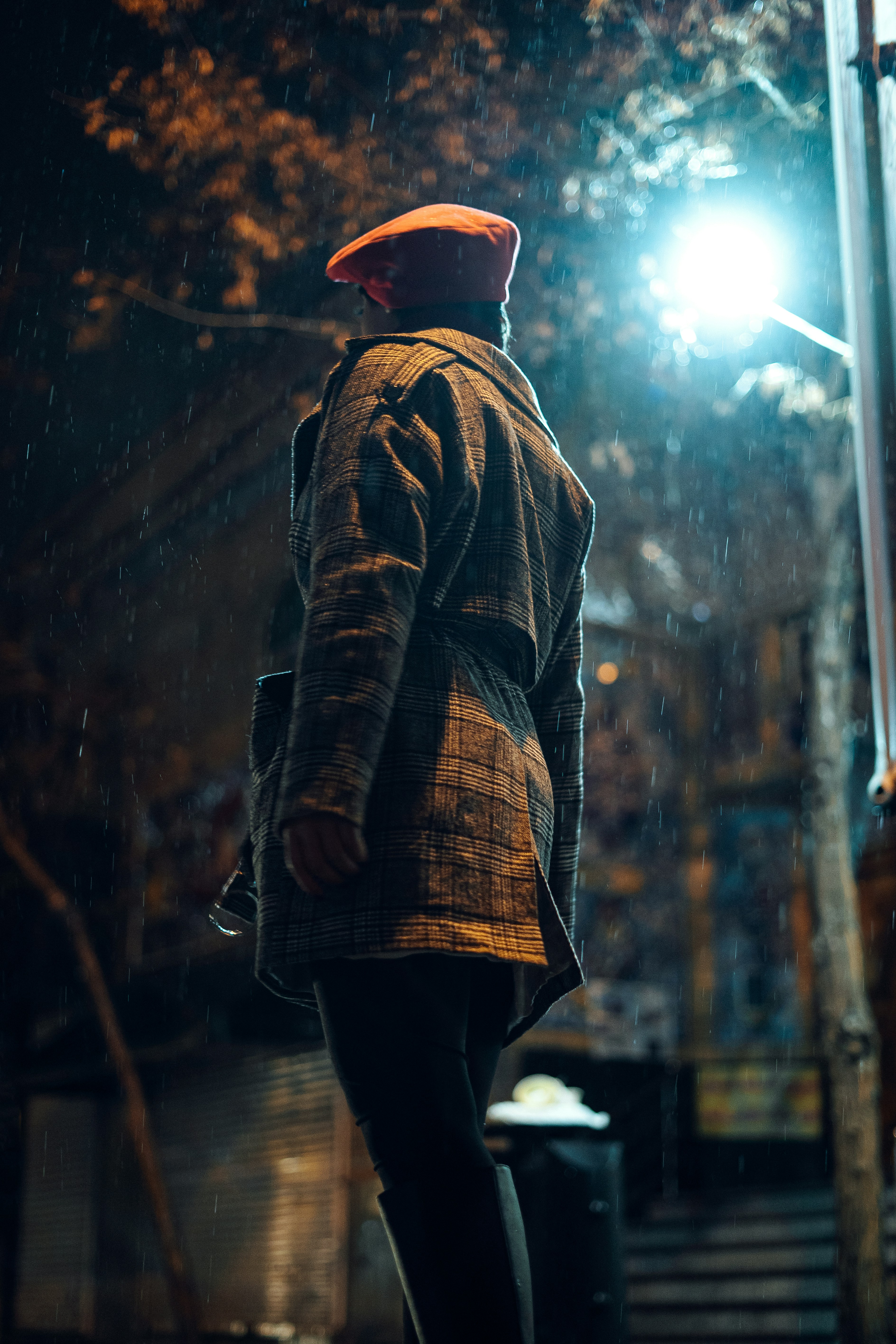 a man walking down a street at night