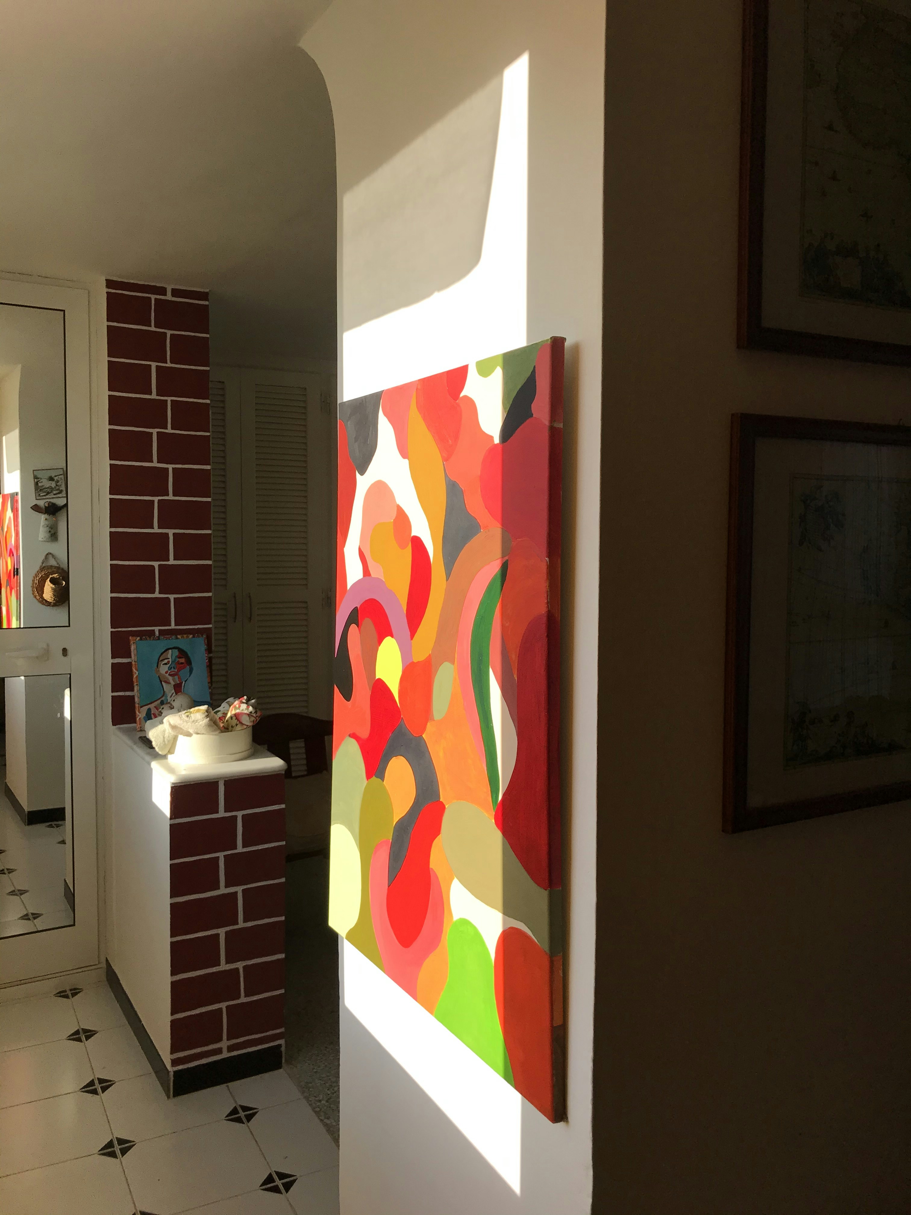 a room with a brick wall and a painting on the wall