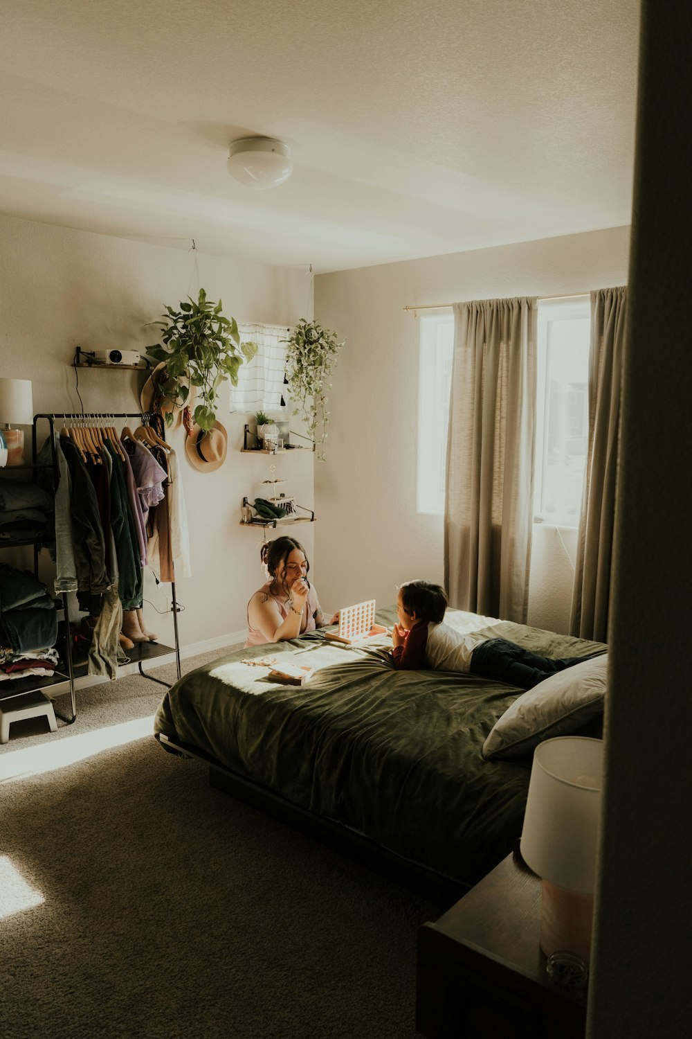 a couple of people laying on top of a bed