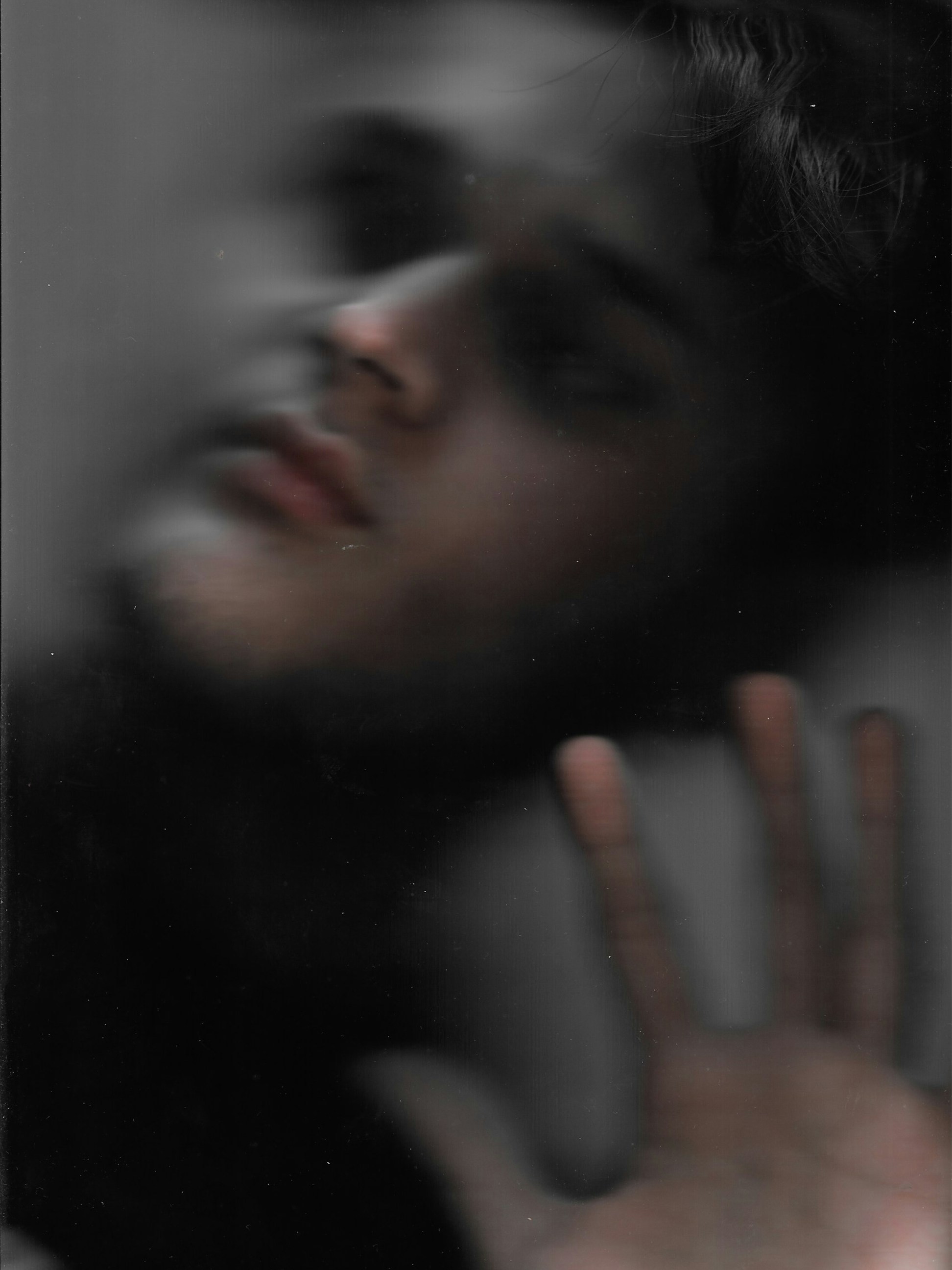 a man with his hand up to his face