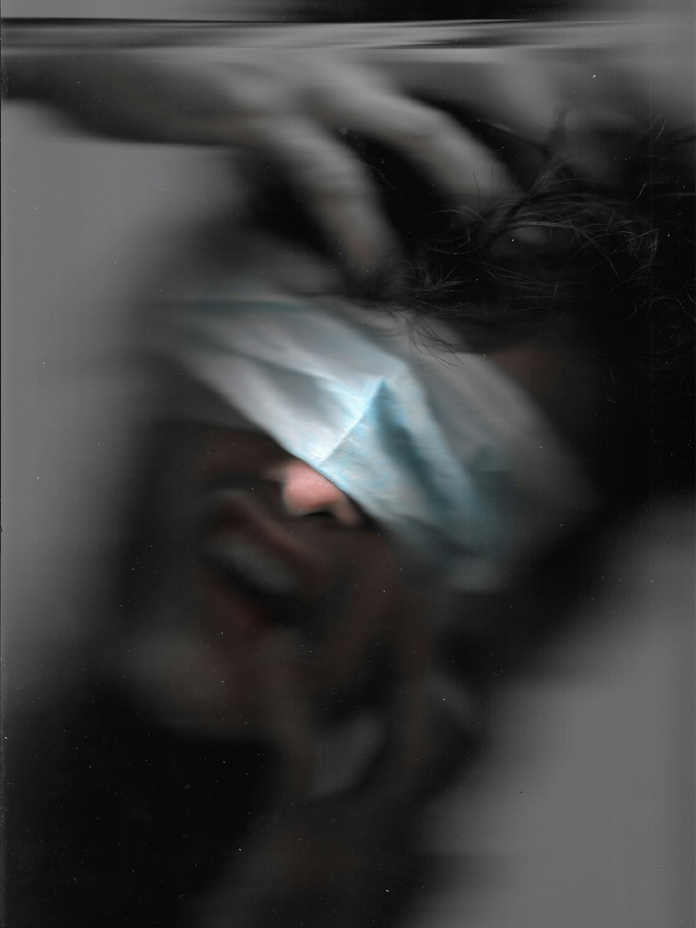 a blurry photo of a person with a blindfold