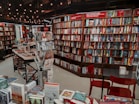 a room filled with lots of books and chairs