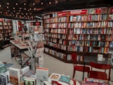 a room filled with lots of books and chairs