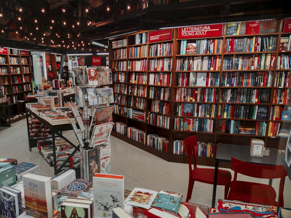 a room filled with lots of books and chairs