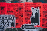 a bunch of posters on the side of a building