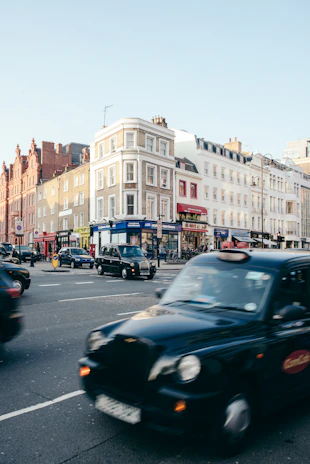 A vialuxe taxi driving past the iconic Birmingham skyline on a sunny afternoon.