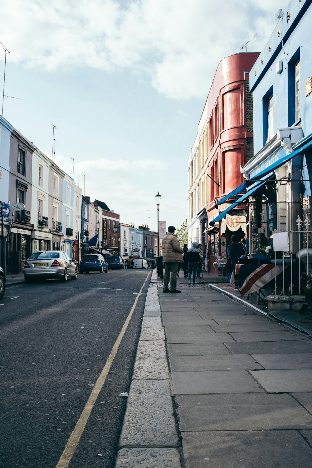 people walking down the sidewalk of a city street