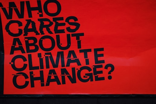 a red sign that says who cares about climate change?