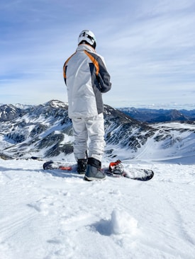 a man standing on top of a snow covered slope