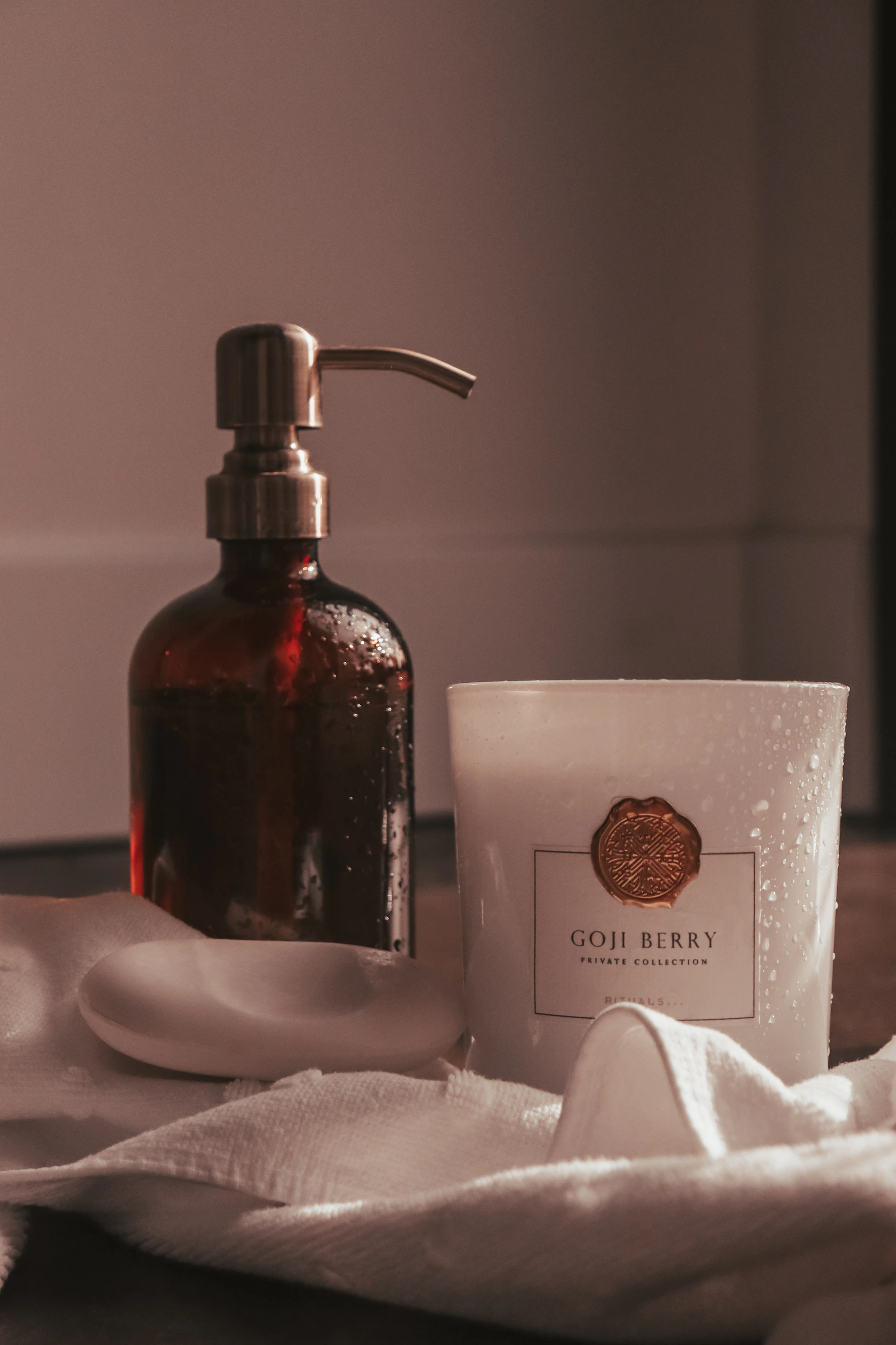 a bottle of soap next to a soap dispenser