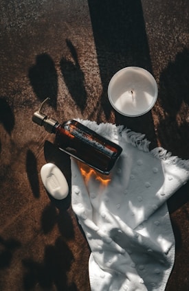a bottle of wine and a candle on a table