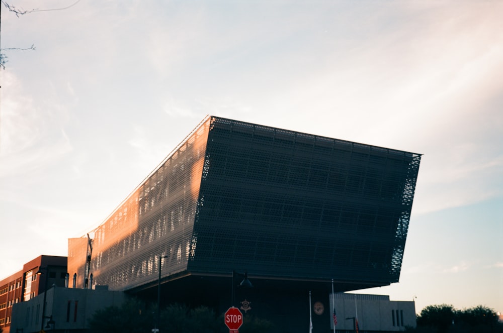 a stop sign in front of a large building