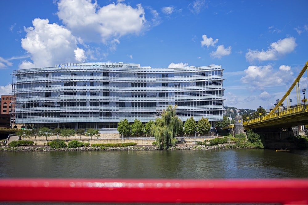 a large office building sitting next to a river