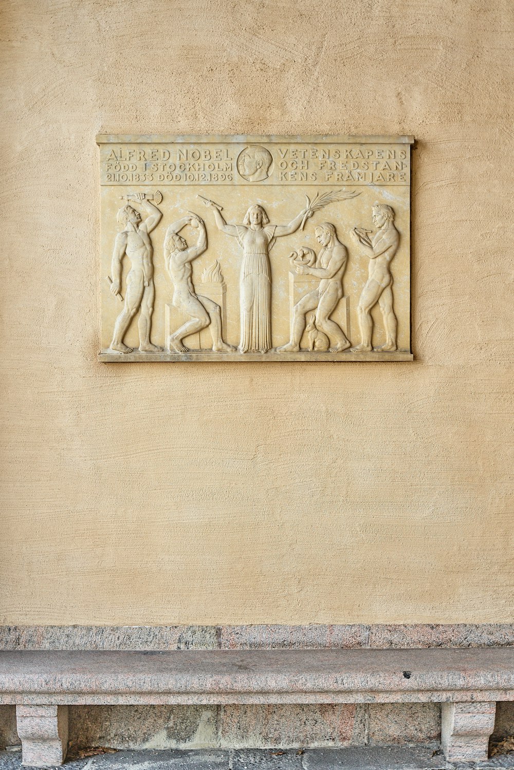 a stone carving of a man and woman on a wall