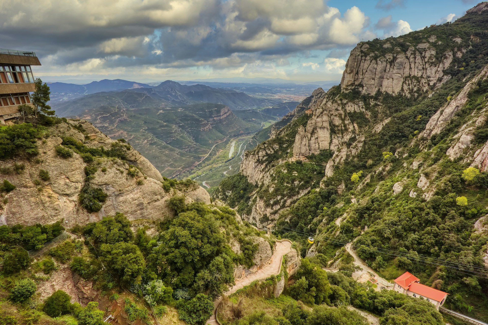 a scenic view of a valley with mountains in the background