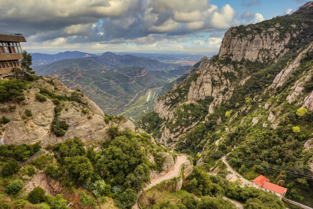 a scenic view of a valley with mountains in the background