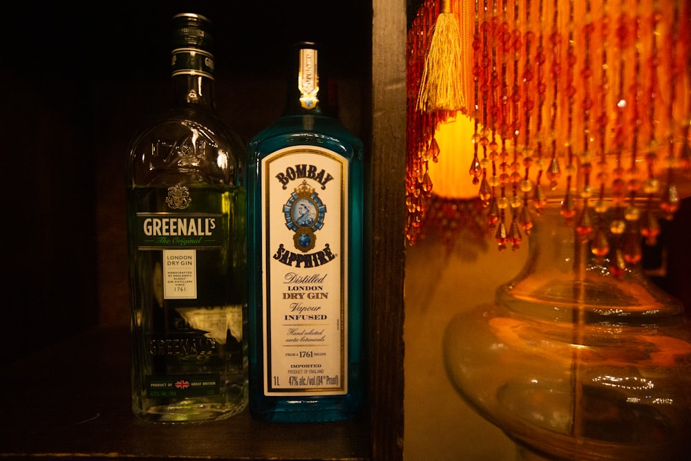 a bottle of liquor sitting next to a lamp