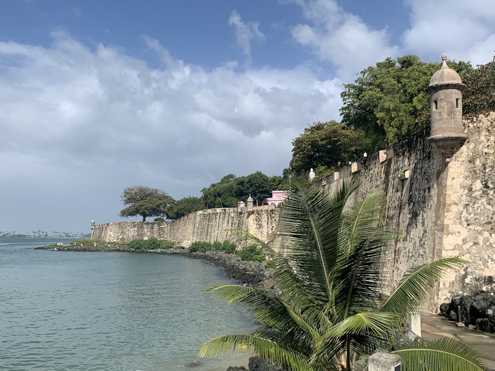 a large body of water next to a stone wall