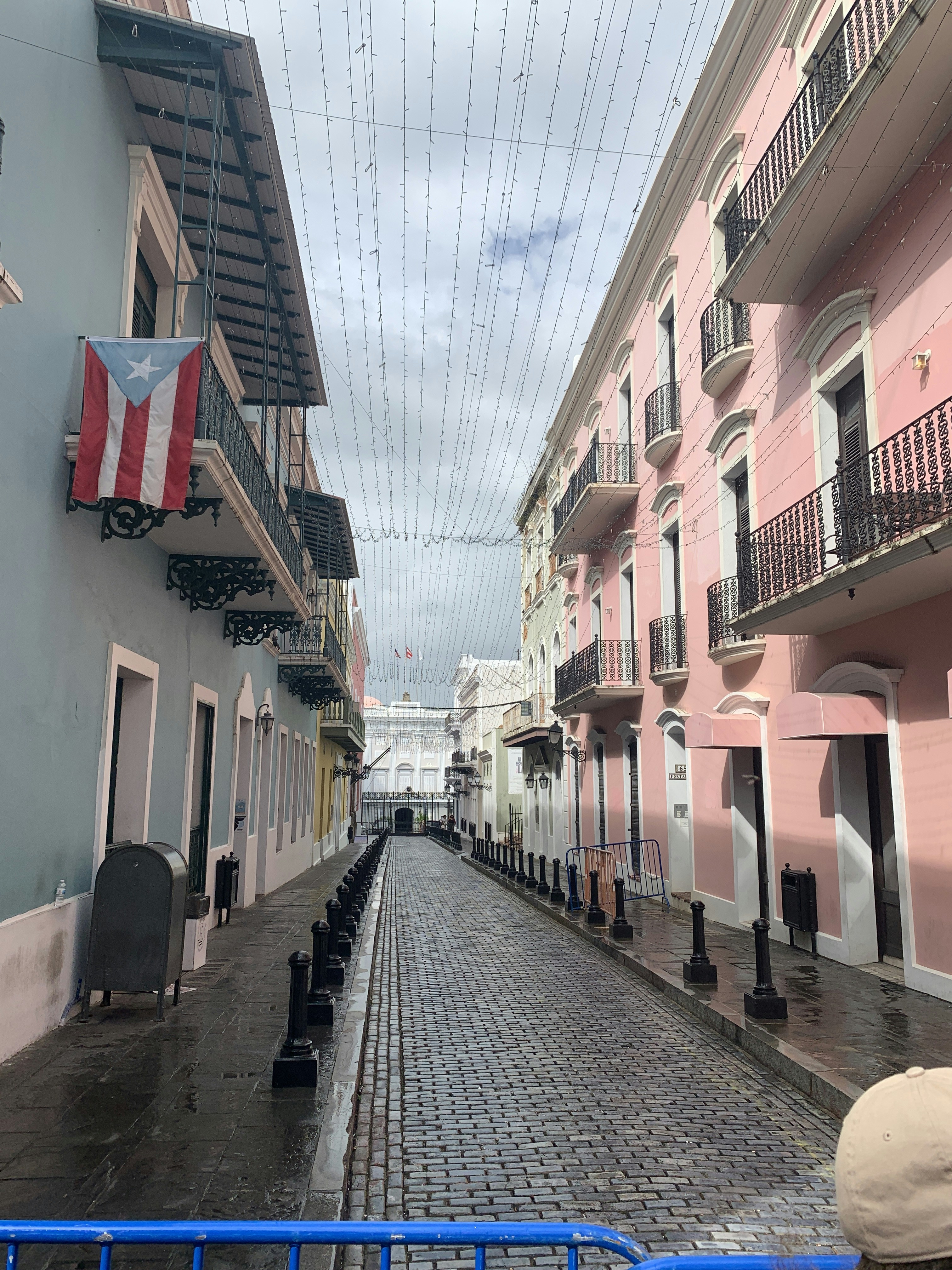 a cobblestone street lined with pink buildings