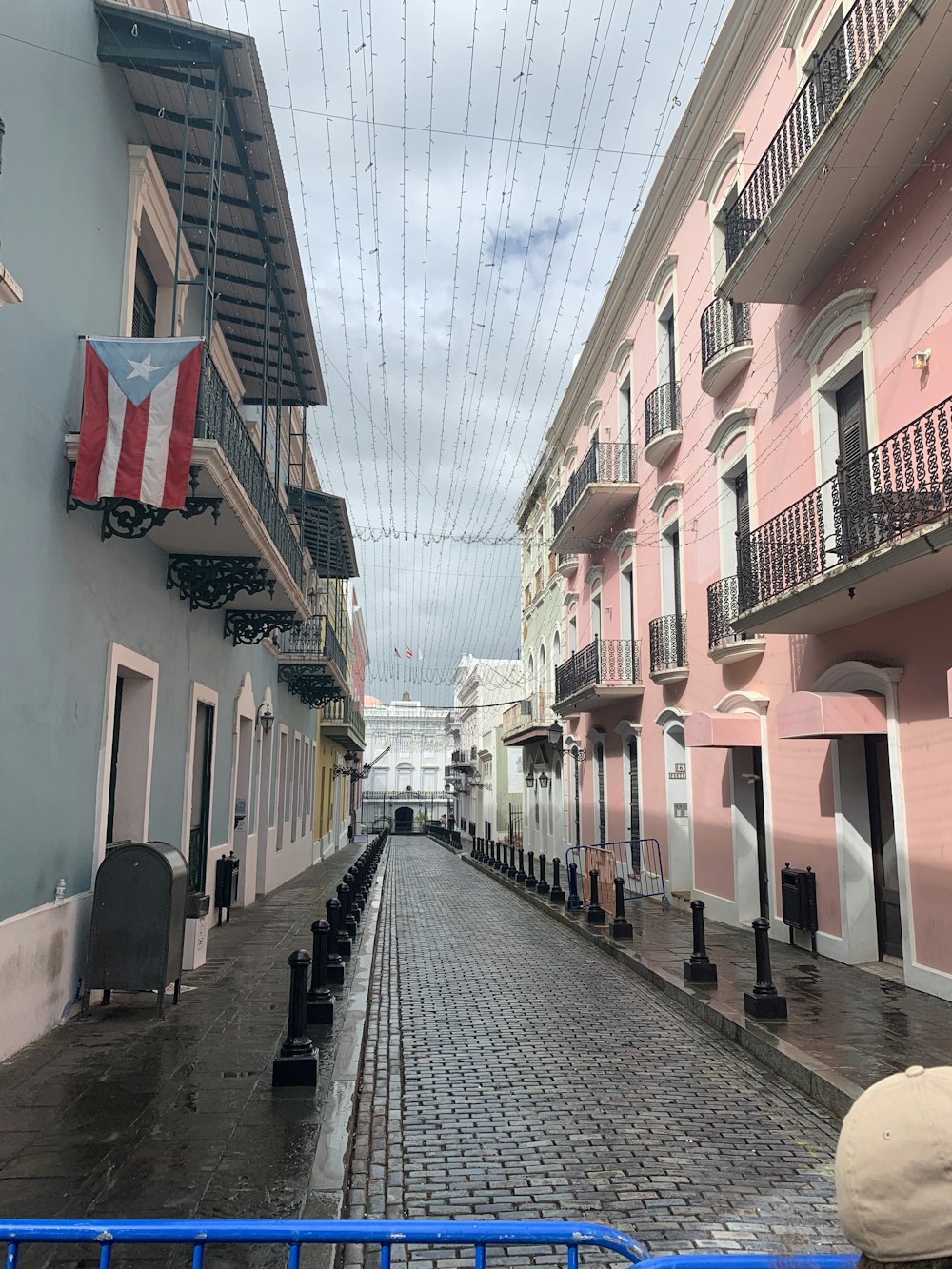 a cobblestone street lined with pink buildings