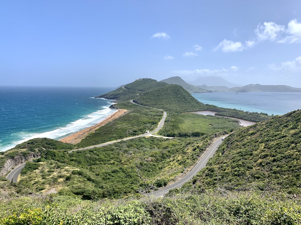 a scenic view of a winding road near the ocean