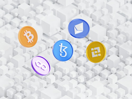 Five cryptocurrency symbols are depicted as coins with distinct logos floating above a pattern of white 3D cubes. The coins represent Bitcoin, Ethereum, Tezos, Polygon, and Binance Coin.