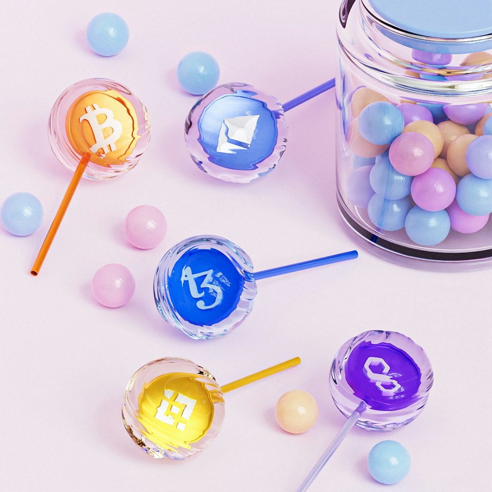 a jar filled with candy and candy lollipops