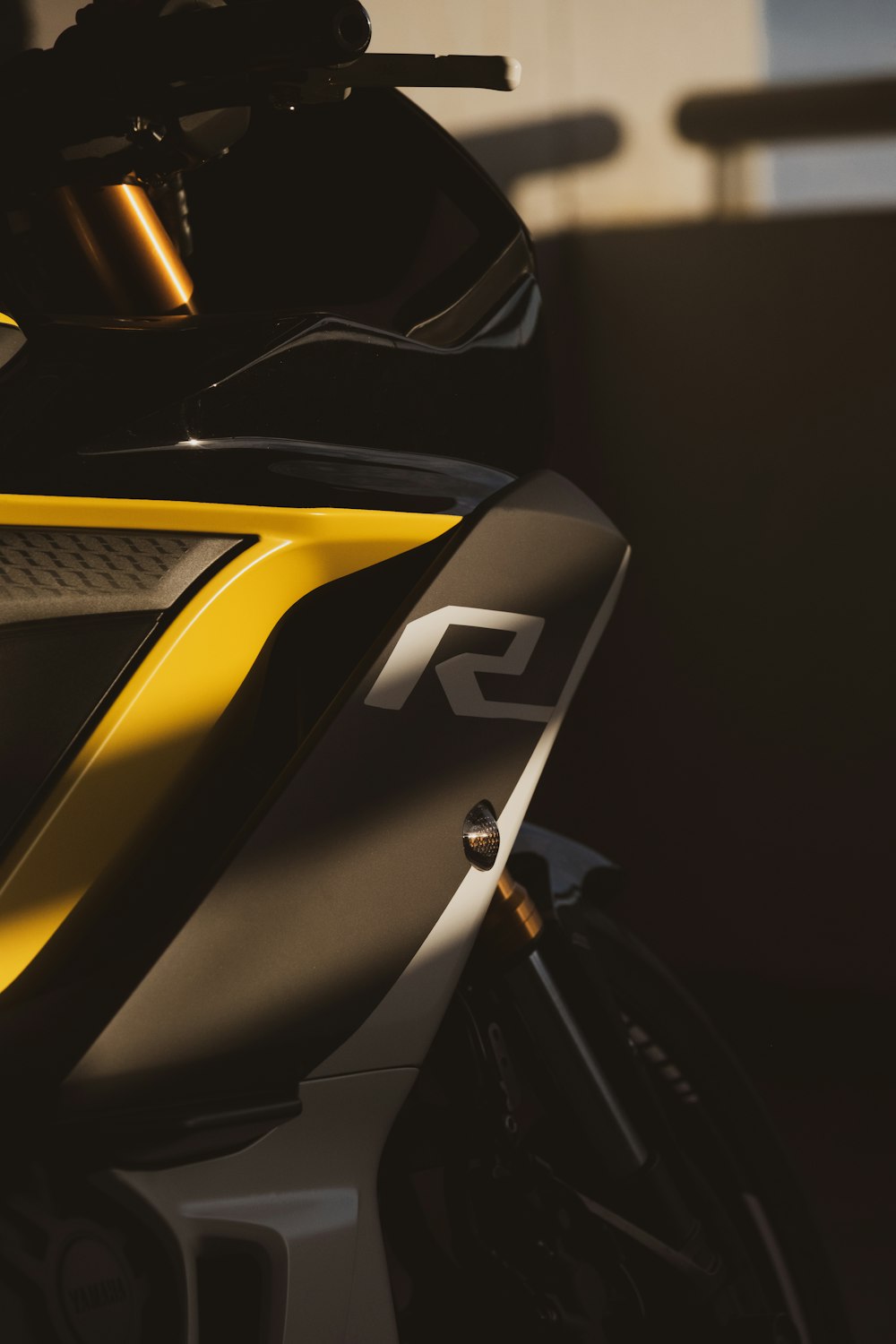 a close up of a yellow and black motorcycle