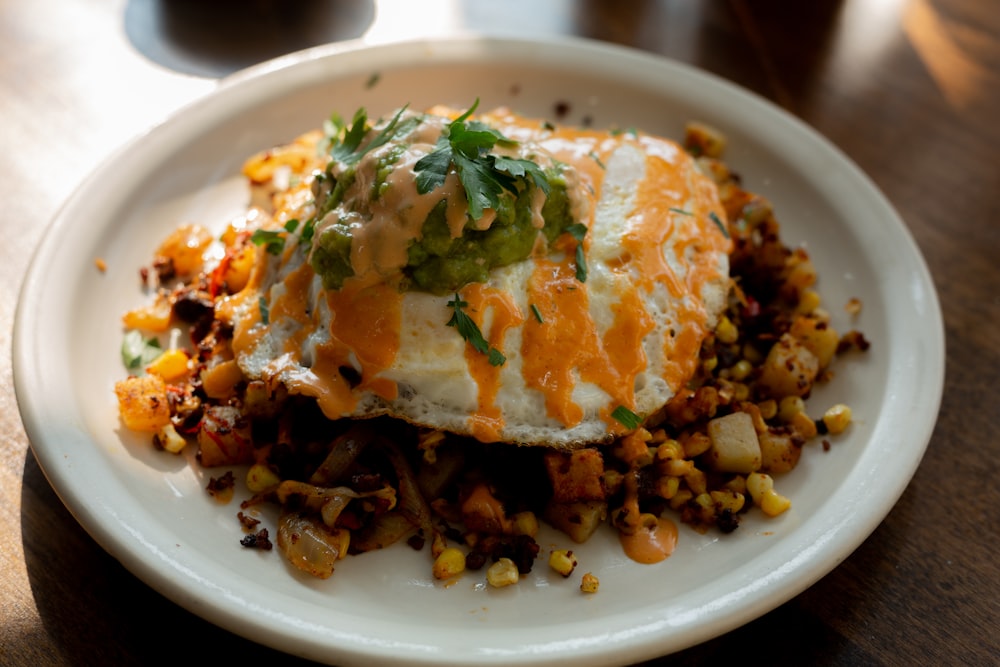 a white plate topped with an egg covered in toppings