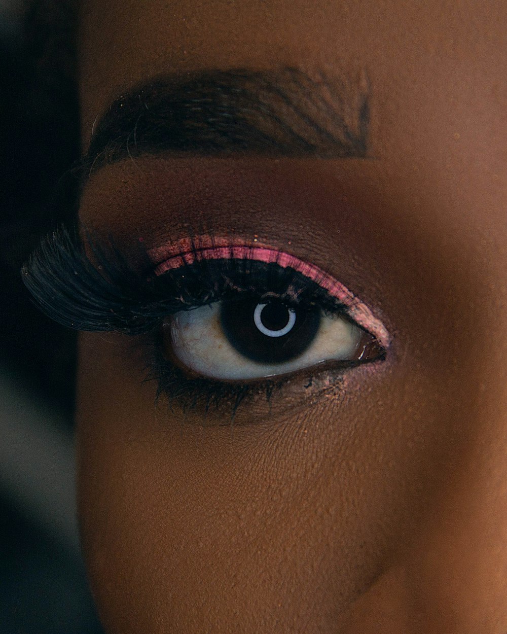 a close up of a woman's eye with long lashes