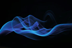 a blurry photo of blue smoke on a black background