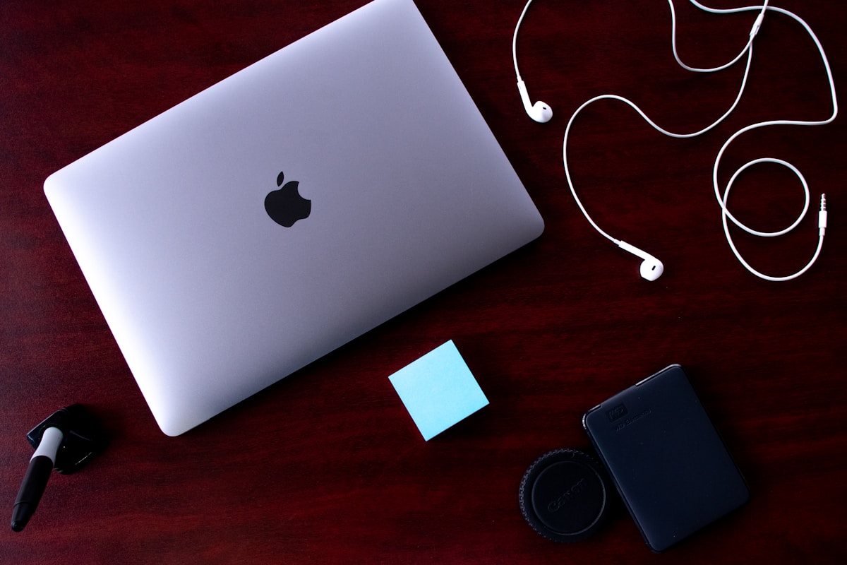 A laptop computer sitting on top of a wooden desk