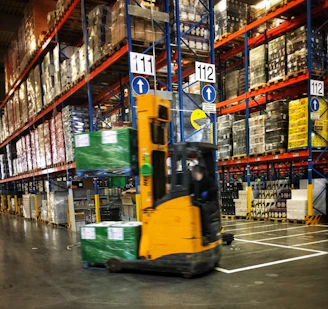 A warehouse with organized inventory shelves and forklifts in motion.