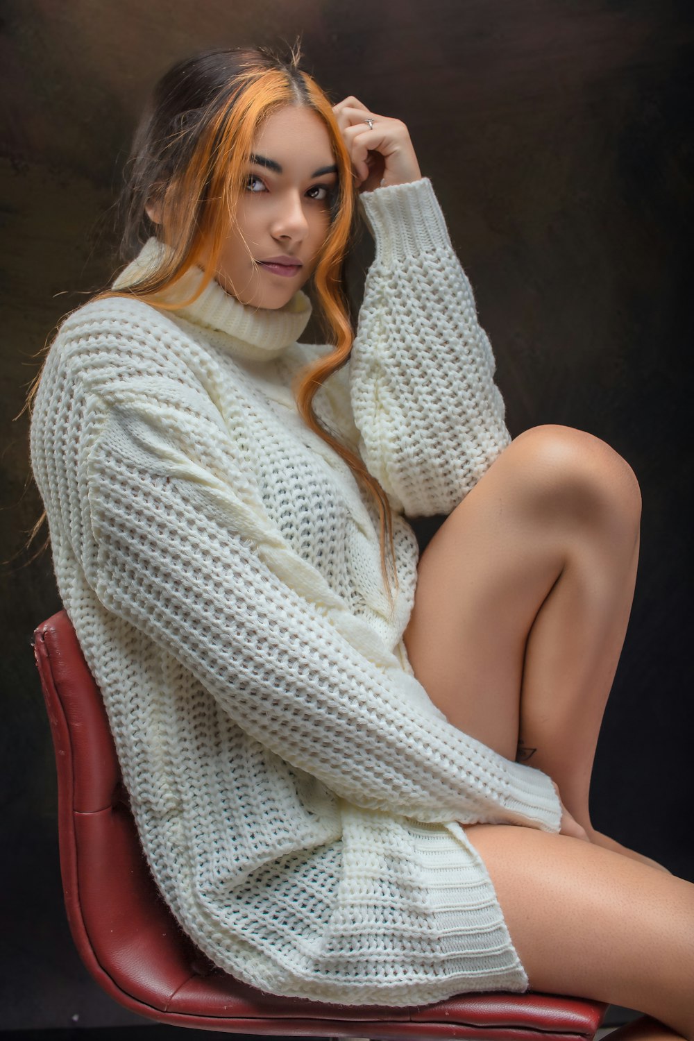 a woman sitting on top of a red chair