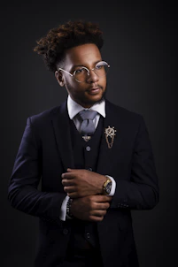 a man in a suit and tie wearing glasses