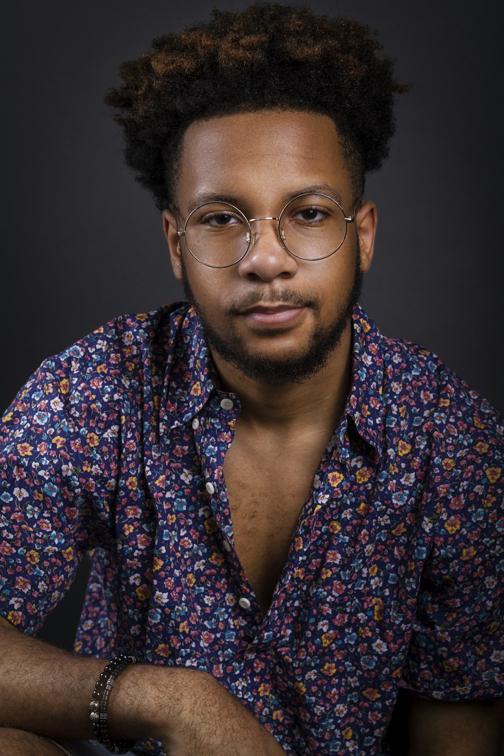 a man with glasses is posing for a picture