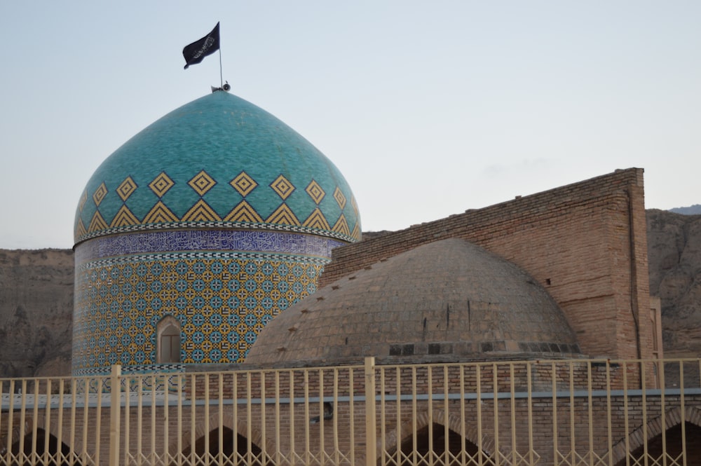 a large blue dome with a flag on top of it