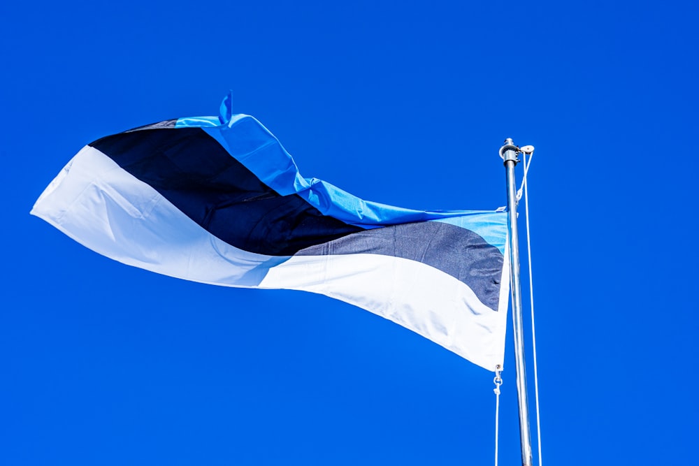 a flag flying in the wind on a clear day