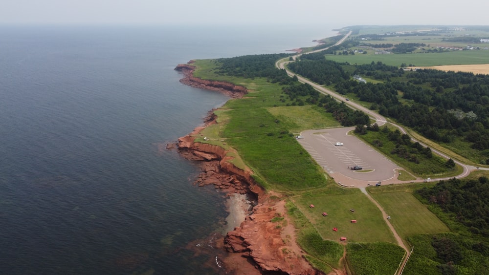 an aerial view of a parking lot next to the ocean