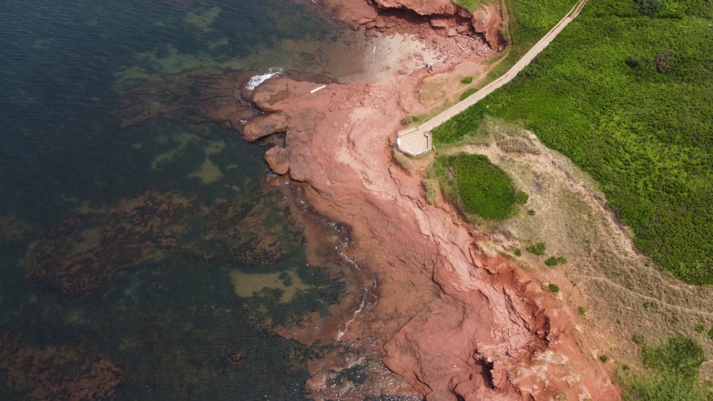 an aerial view of a road near the ocean